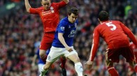 Liverpool's Jay Spearing (L) closes in o
